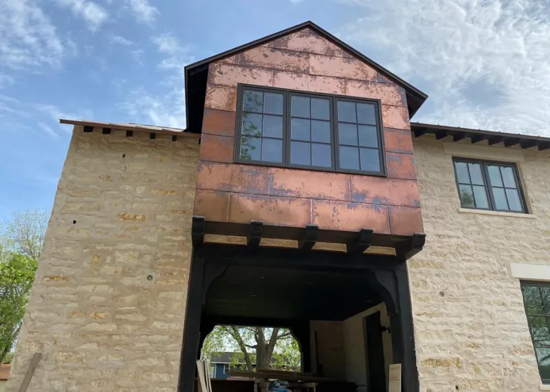 Copper metal panel facade on a stone building for Roof Repair in Largo