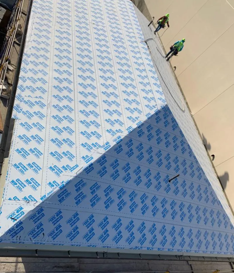 Professional roofers installing underlayment on a metal roof in Largo